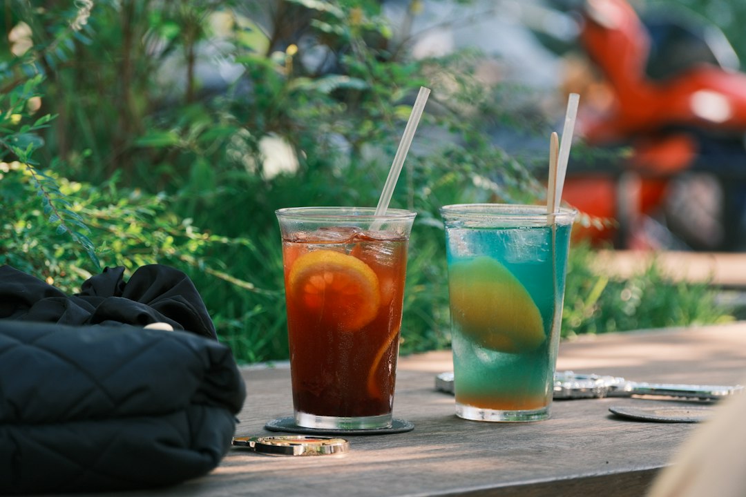 Two refreshing iced citrus drinks with garnishes